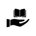 Hand giving book icon. Open book in hand. Black silhouette. Royalty Free Stock Photo